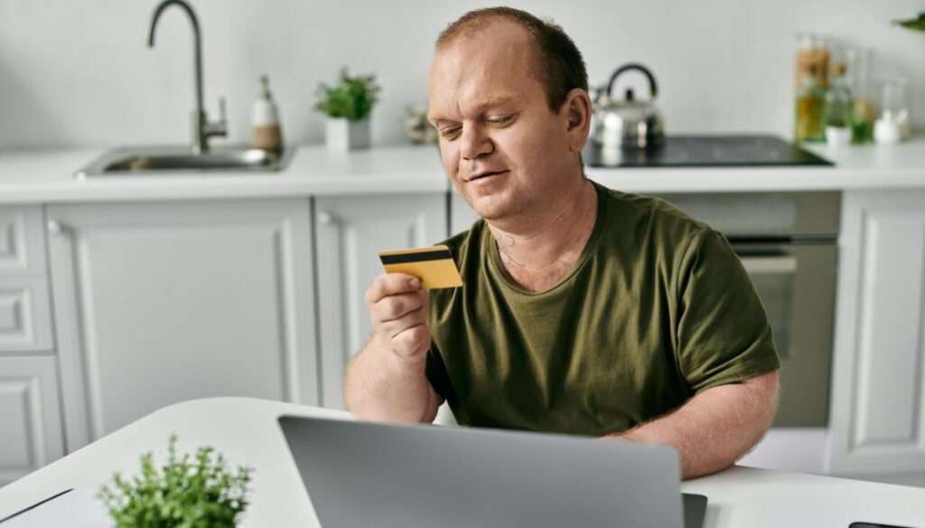 Man Reviewing Credit Card at Home